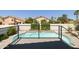 Modern pool with water feature, viewed from deck, with lush landscaping and privacy wall at 6174 E Janice Way, Scottsdale, AZ 85254