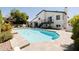 Inviting pool with travertine decking, set against a modern two-story home, ideal for summer enjoyment at 6174 E Janice Way, Scottsdale, AZ 85254