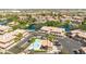 Aerial view showcasing the community with a pond, pool, and well-maintained buildings, and palm trees at 6535 E Superstition Springs Blvd # 146, Mesa, AZ 85206