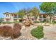 Building exterior showing a decorative fountain, green foliage, and multiple floors at 6535 E Superstition Springs Blvd # 146, Mesa, AZ 85206