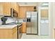 Bright kitchen featuring stainless steel appliances and blonde wood cabinetry at 6535 E Superstition Springs Blvd # 146, Mesa, AZ 85206
