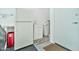 Utility room with a full-size refrigerator, laundry sink, and doorway to the exterior at 6535 E Superstition Springs Blvd # 146, Mesa, AZ 85206