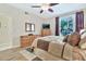 Bedroom featuring ceiling fan, balcony access, and well-lit interior at 6535 E Superstition Springs Blvd # 146, Mesa, AZ 85206