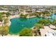 Scenic aerial view of a pond surrounded by lush greenery and trees in a well-maintained community at 6535 E Superstition Springs Blvd # 146, Mesa, AZ 85206
