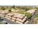 Aerial view of well-maintained townhomes with tile roofs, attached garages, and views of a golf course at 6535 E Superstition Springs Blvd # 146, Mesa, AZ 85206