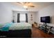 Bedroom featuring hardwood floors, a bed and a television at 7126 N 19Th Ave # 122, Phoenix, AZ 85021