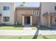 A tan, two-story apartment complex with columned entryway and a green lawn in front at 7126 N 19Th Ave # 122, Phoenix, AZ 85021