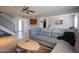 An open-concept living room with gray sofa, ceiling fan, and tile flooring at 7126 N 19Th Ave # 122, Phoenix, AZ 85021
