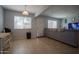 Open living room area with tile flooring, light gray paint and large sofa at 7126 N 19Th Ave # 122, Phoenix, AZ 85021