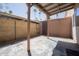 Covered outdoor patio area with a chain-link fence and concrete flooring at 7126 N 19Th Ave # 122, Phoenix, AZ 85021