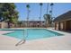 A sparkling community pool surrounded by palm trees and manicured landscaping at 7126 N 19Th Ave # 122, Phoenix, AZ 85021