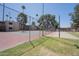 Community tennis court surrounded by mature trees and landscaping at 7126 N 19Th Ave # 122, Phoenix, AZ 85021