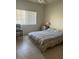 Bright bedroom with tile flooring, a large window, a comfortable bed, and a bedside table at 7609 E Indian Bend Rd # 1012, Scottsdale, AZ 85250