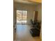 Bedroom area with sliding glass door to patio, tile floors, desk, and chair at 7609 E Indian Bend Rd # 1012, Scottsdale, AZ 85250
