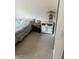Comfortable bedroom with tile flooring, a large window, a bedside table, and bedside lamp at 7609 E Indian Bend Rd # 1012, Scottsdale, AZ 85250