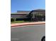 Exterior view of a building with landscaping, palm trees, and visible signage at 7609 E Indian Bend Rd # 1012, Scottsdale, AZ 85250