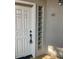 Condo entrance with a white door, glass block sidelight, and unit number 1012 at 7609 E Indian Bend Rd # 1012, Scottsdale, AZ 85250