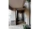 Covered walkway outside of apartments, showing tile floors, rock pillars, and apartment doors at 7609 E Indian Bend Rd # 1012, Scottsdale, AZ 85250