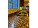 Kitchen countertop with sink, stone countertops, and view to dining table at 7609 E Indian Bend Rd # 1012, Scottsdale, AZ 85250