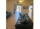 Living room area with green sofas, and an entrance to a patio with table and chairs at 7609 E Indian Bend Rd # 1012, Scottsdale, AZ 85250