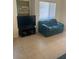 Living room with TV on console, window with blinds, and love seat at 7609 E Indian Bend Rd # 1012, Scottsdale, AZ 85250