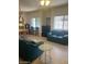Open concept living room with tile floors, light fixture, and sofas at 7609 E Indian Bend Rd # 1012, Scottsdale, AZ 85250