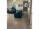 Inviting living room featuring matching blue couches and access to a hallway at 7609 E Indian Bend Rd # 1012, Scottsdale, AZ 85250