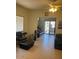 Comfortable living room with tile floors, a ceiling fan, and a view of the outdoor patio at 7609 E Indian Bend Rd # 1012, Scottsdale, AZ 85250