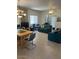 Open-concept living room with a dining area and blue sofas, perfect for entertaining at 7609 E Indian Bend Rd # 1012, Scottsdale, AZ 85250