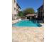 Community pool area with inviting blue water and surrounding lounge chairs and tiled deck at 7609 E Indian Bend Rd # 1012, Scottsdale, AZ 85250