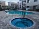 Community pool area featuring a large pool, hot tub, and comfortable lounge seating at 7609 E Indian Bend Rd # 1012, Scottsdale, AZ 85250