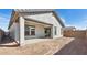 Back of home featuring a covered patio and sliding glass doors, set in a spacious yard awaiting personalization at 7657 W Minton St, Laveen, AZ 85339
