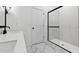 Updated bathroom showcasing a sleek glass shower enclosure with a modern sink and black hardware at 7657 W Minton St, Laveen, AZ 85339