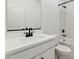 Clean bathroom with a single vanity, a toilet, and a tub/shower combo with white marble surround at 7657 W Minton St, Laveen, AZ 85339
