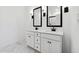 Bright bathroom with double sink vanity featuring modern fixtures, white cabinets, and stylish marble flooring at 7657 W Minton St, Laveen, AZ 85339