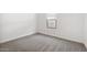 Bright bedroom with neutral carpet, a single window, and white walls at 7657 W Minton St, Laveen, AZ 85339