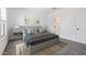 Stylishly staged bedroom featuring a gray bed frame, accent pillows, and a calming art piece at 7657 W Minton St, Laveen, AZ 85339