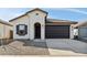 Charming single-story home with a neutral color palette and a dark brown two car garage at 7657 W Minton St, Laveen, AZ 85339