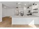 Modern kitchen featuring a white island, pendant lights, and stainless steel appliances at 7657 W Minton St, Laveen, AZ 85339