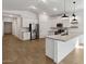 Bright open kitchen with a large island, pendant lighting, and stainless steel appliances at 7657 W Minton St, Laveen, AZ 85339