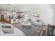 Bright, open-concept living room featuring white walls, modern decor, and an adjacent kitchen at 7657 W Minton St, Laveen, AZ 85339