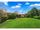 Expansive backyard with lush lawn and mature landscaping offering serene outdoor living at 7746 E Bisbee Rd, Scottsdale, AZ 85258