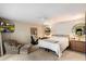 Comfortable bedroom with ceiling fan, TV, chair, and backyard view at 7746 E Bisbee Rd, Scottsdale, AZ 85258