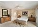 Bedroom featuring ceiling fan, comfortable bed, mirror, and artwork at 7746 E Bisbee Rd, Scottsdale, AZ 85258