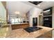 This modern kitchen boasts granite countertops, an island cooktop, and state-of-the-art stainless steel appliances at 7746 E Bisbee Rd, Scottsdale, AZ 85258