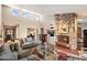 Spacious living room with a stone fireplace, high ceilings, and a comfortable seating area at 7746 E Bisbee Rd, Scottsdale, AZ 85258