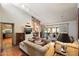Cozy living room with stone fireplace, TV, comfortable sofas, and tile floors at 7746 E Bisbee Rd, Scottsdale, AZ 85258