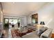 Bright living room featuring tile floors, neutral furniture, and sliding glass doors to outdoor seating at 7746 E Bisbee Rd, Scottsdale, AZ 85258