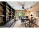 Office featuring a desk and chair, bookcase and sliding glass door to the backyard at 7746 E Bisbee Rd, Scottsdale, AZ 85258