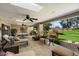 Relaxing covered patio with multiple seating areas overlooking the lush green yard at 7746 E Bisbee Rd, Scottsdale, AZ 85258
